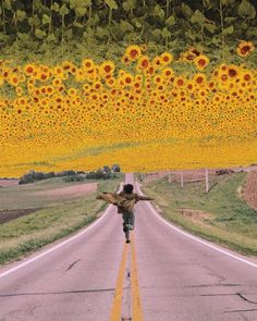 a man walking down the middle of a road with sunflowers hanging from the ceiling