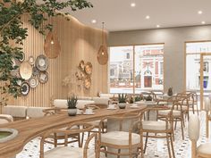 the interior of a restaurant with tables, chairs and potted plants on the wall