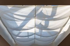 shadows cast on white fabric covering the ceiling