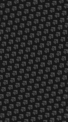 a black and gray pattern with skulls on it