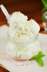 a glass jar filled with whipped cream on top of a table next to a napkin