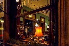 a lamp is lit up in the window of a restaurant