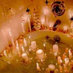 candles are arranged in the middle of a bathtub surrounded by stars and confetti