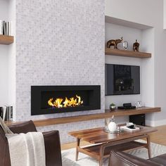 a living room filled with furniture and a fire place in the middle of the wall