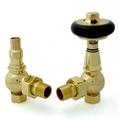 two brass colored faucets with black knobs on each side and an outlet for the faucet