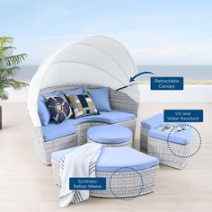 an outdoor furniture set with blue cushions and pillows on the floor next to a potted plant