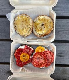 two plastic containers filled with food on top of a wooden table