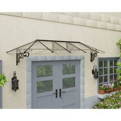 the front door to a house with potted plants