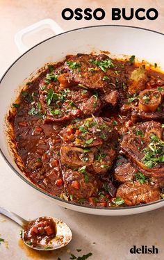 a pot filled with meat and sauce on top of a table