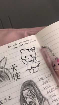 an open notebook with some drawings on it and a pen in front of the book