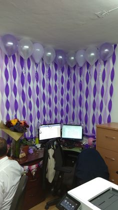 an office decorated with balloons and streamers