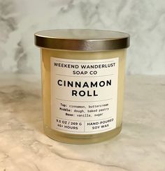 a close up of a jar of cinnamon roll on a marble counter top with a metal lid