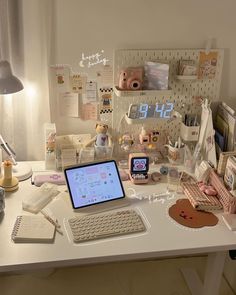 a laptop computer sitting on top of a white desk