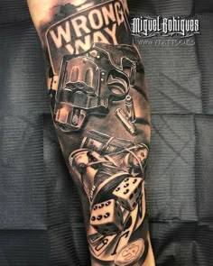 a man's leg with a tattoo on it that says wrong way and various items