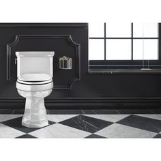 a white toilet sitting next to a black and white checkered floor