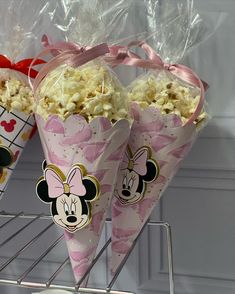 three cones filled with popcorn and minnie mouse faces