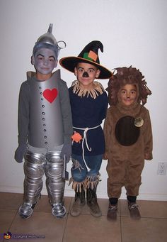 three children dressed in costumes standing next to each other