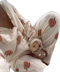 a baby wrapped in a blanket with an apple print on it