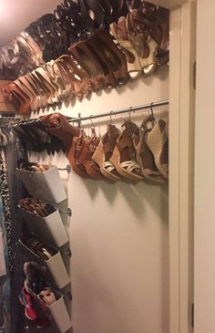 there are many pairs of shoes hanging on the wall