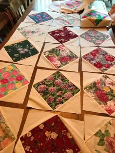 the table is covered with many different pieces of fabric and quilted together in squares