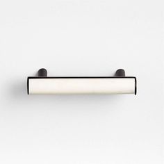 a black and white light fixture on a wall