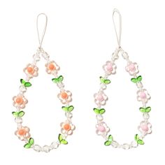 two pairs of hoop earrings with flowers and leaves hanging from the end of each ear