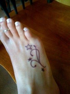 a woman's foot with a star tattoo on it