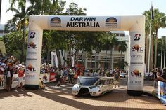 an old car is parked under a white arch with the words dawn australia on it