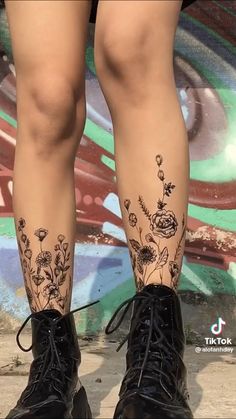 the legs and ankles of a woman with tattoos