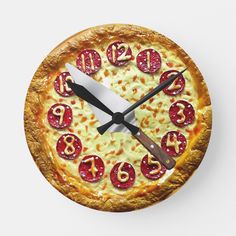 a clock made to look like a pizza with numbers on it