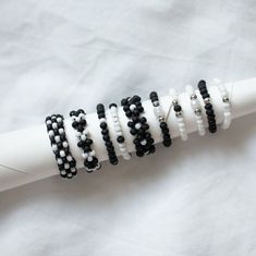 black and white beaded bracelets sitting on top of a white napkin with a toothbrush