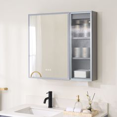 a bathroom with a sink, mirror and towel dispenser