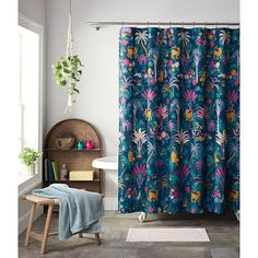 a bathroom with a shower curtain and rug