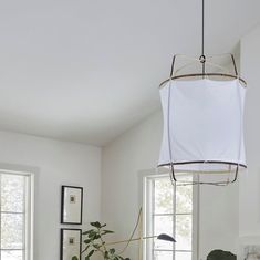 a living room filled with furniture and plants