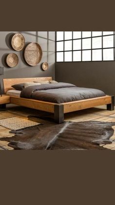 a bed sitting on top of a wooden floor next to a wall with baskets above it