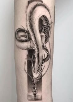 a black and white photo of a tattoo on the leg