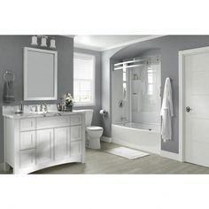 a bathroom with gray walls and white fixtures