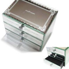 an open jewelry box sitting on top of a white table