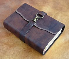 a brown leather book with a chain on it