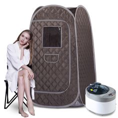 a woman sitting on a chair next to a portable shower