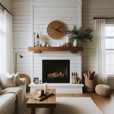 a living room filled with furniture and a fire place in the middle of a wall