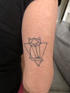 a woman with a tattoo on her arm that has an origami design on it