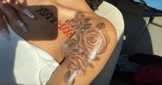 a woman with a rose tattoo on her arm