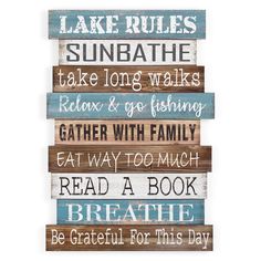 a wooden sign that says lake rules, sunbathe, take long walks, relax and go fishing