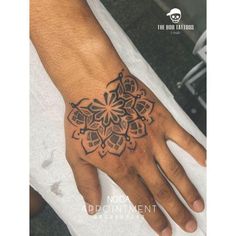 a person's hand with a tattoo on it