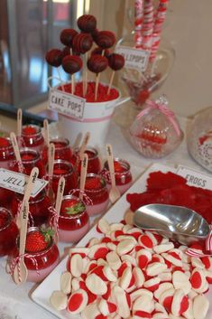 desserts and candies displayed on a table at a valentine's day party