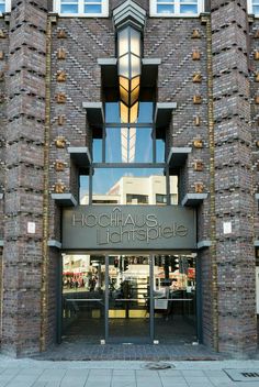 the front entrance to a building with large windows