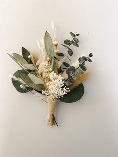 an arrangement of flowers and leaves on a white background