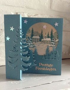 a christmas card with a house in the background and trees on it's side