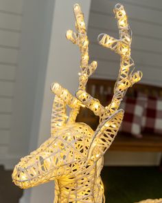 a light up deer statue with lights on it's head and antlers attached to its neck